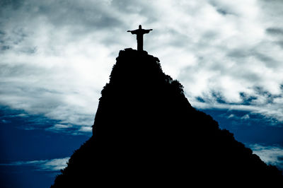 Low angle view of silhouette statue against sky