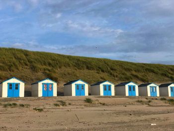Row of beach huts against sky