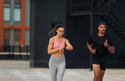 Portrait of young woman exercising in gym