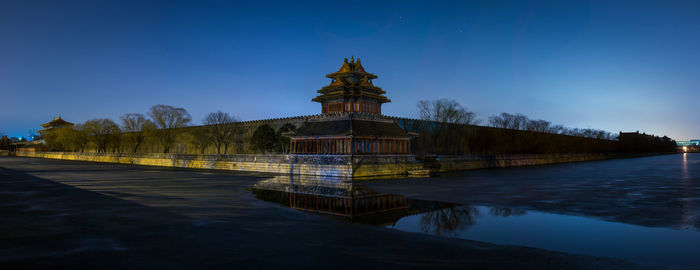 View of sculpture by lake against sky