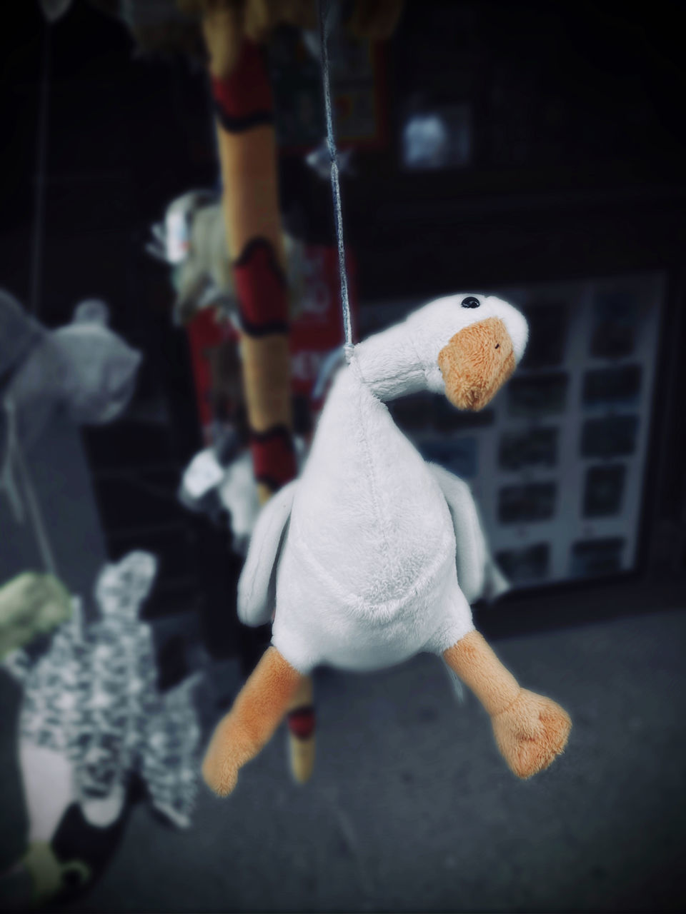 CLOSE-UP OF STUFFED TOY HANGING IN PARK