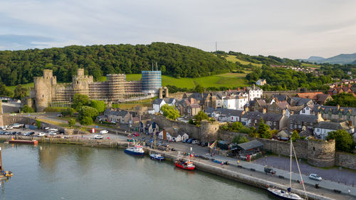 High angle view of buildings by river against sky