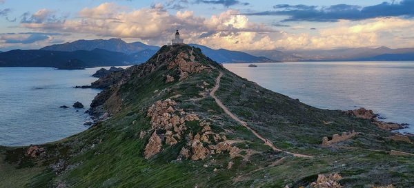 Scenic view of sea and mountains against sky