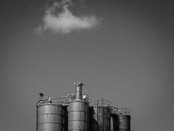 Low angle view of industrial building against sky on sunny day