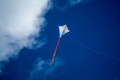 Low angle view of vapor trail against blue sky