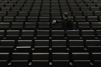 Man sitting on chair in auditorium