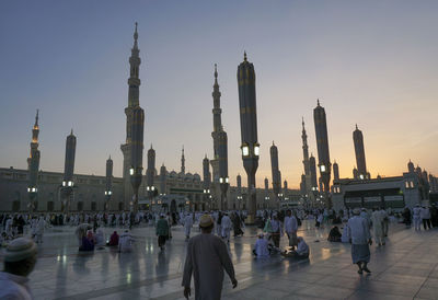Pilgrims at al-masjid an-nabawi against sky