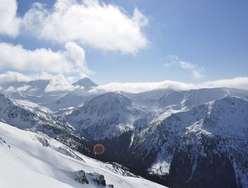 Scenic view of snow covered mountains against sky