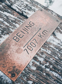 High angle view of information sign on wood