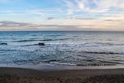 Scenic view of beach against sky during sunset