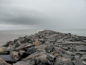 Scenic view of sea against cloudy sky