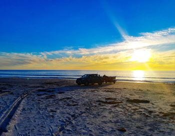 Scenic view of beach against sky during sunset