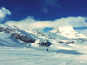 Scenic view of snow covered mountains against sky