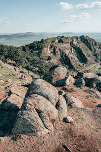 Rounded rock formations on top of arid mountain range