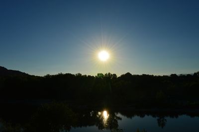 Sun shining over calm lake