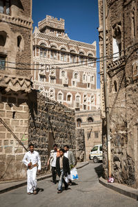 Rear view of people walking in historic building