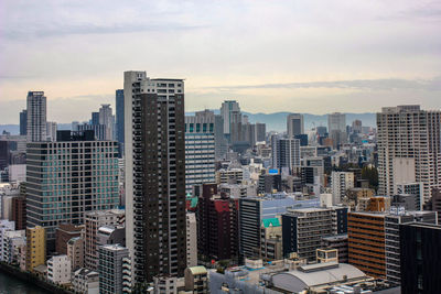 High angle view of buildings in city against sky