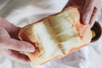 Cropped hand of person holding bread