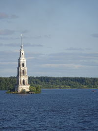 Church by building against sky