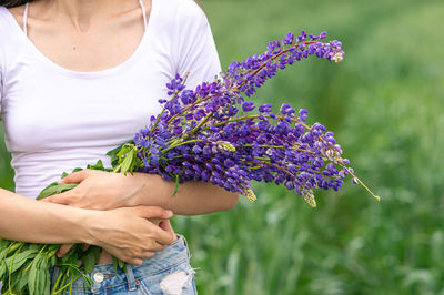 Midsection of woman holding plant