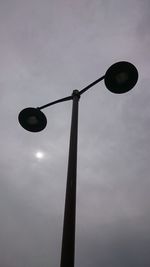 Low angle view of street light against sky