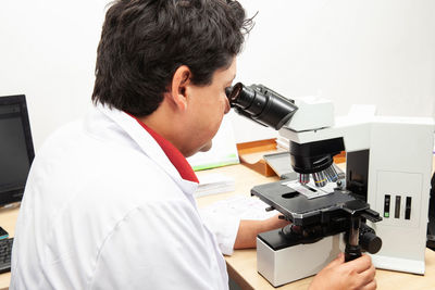 Side view of man using mobile phone