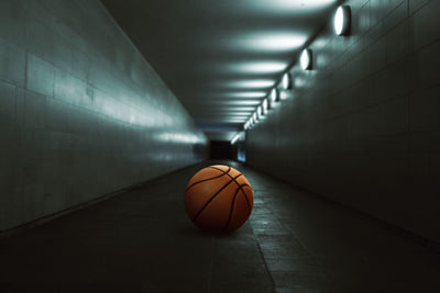 Basketball in illuminated tunnel