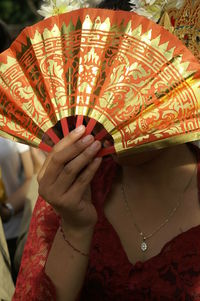 Midsection of woman holding umbrella