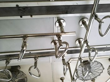 Low angle view of handles in train