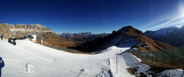 Scenic view of mountains against blue sky