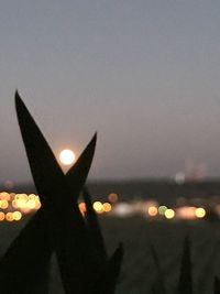 Close-up of illuminated city against sky at night