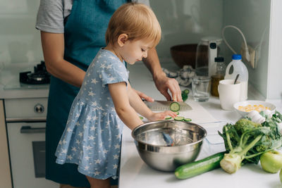 Portrait of cute girl preparing food at home