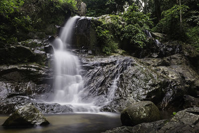 Waterfall through rock formations in hutan lipur jeram tengkek