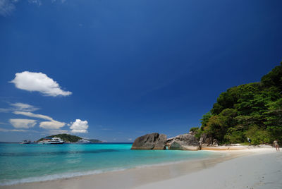 Scenic view of beach against blue sky