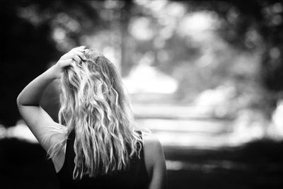 Rear view of woman with hand in hair