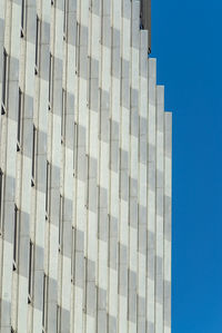 Low angle view of modern building against blue sky