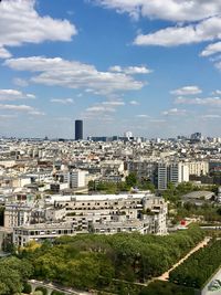 High angle view of trees and buildings in paris with view on montparnasse tower 