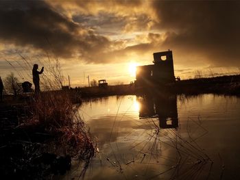 Scenic view of lake at sunset