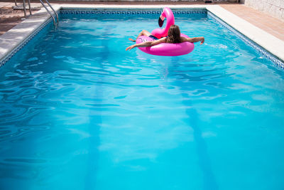 High angle view of woman swimming in pool