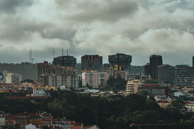 Cityscape against cloudy sky