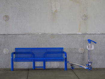 Blue deck chairs against wall