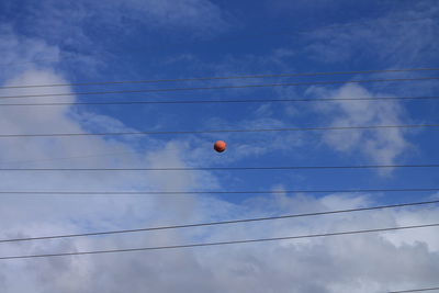 Low angle view of hot air balloon against blue sky