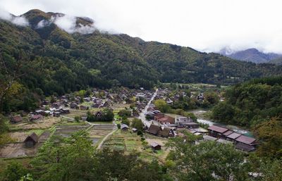 High angle view of trees and buildings against sky