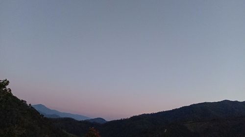 Scenic view of silhouette mountains against clear sky