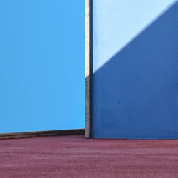 Low angle view of wall against blue sky