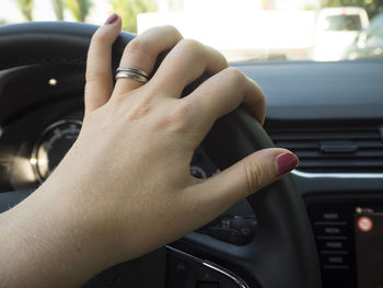 Close-up of woman hand in car