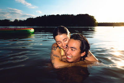 Portrait of young woman swimming in sea