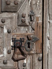 Knocker on old wooden door during sunny day