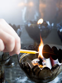 Person holding burning candles