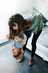 Mother and girl wearing hat on floor